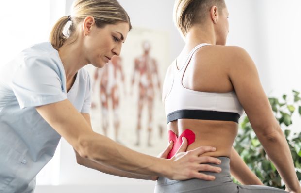 Modern rehabilitation physiotherapy worker with woman client